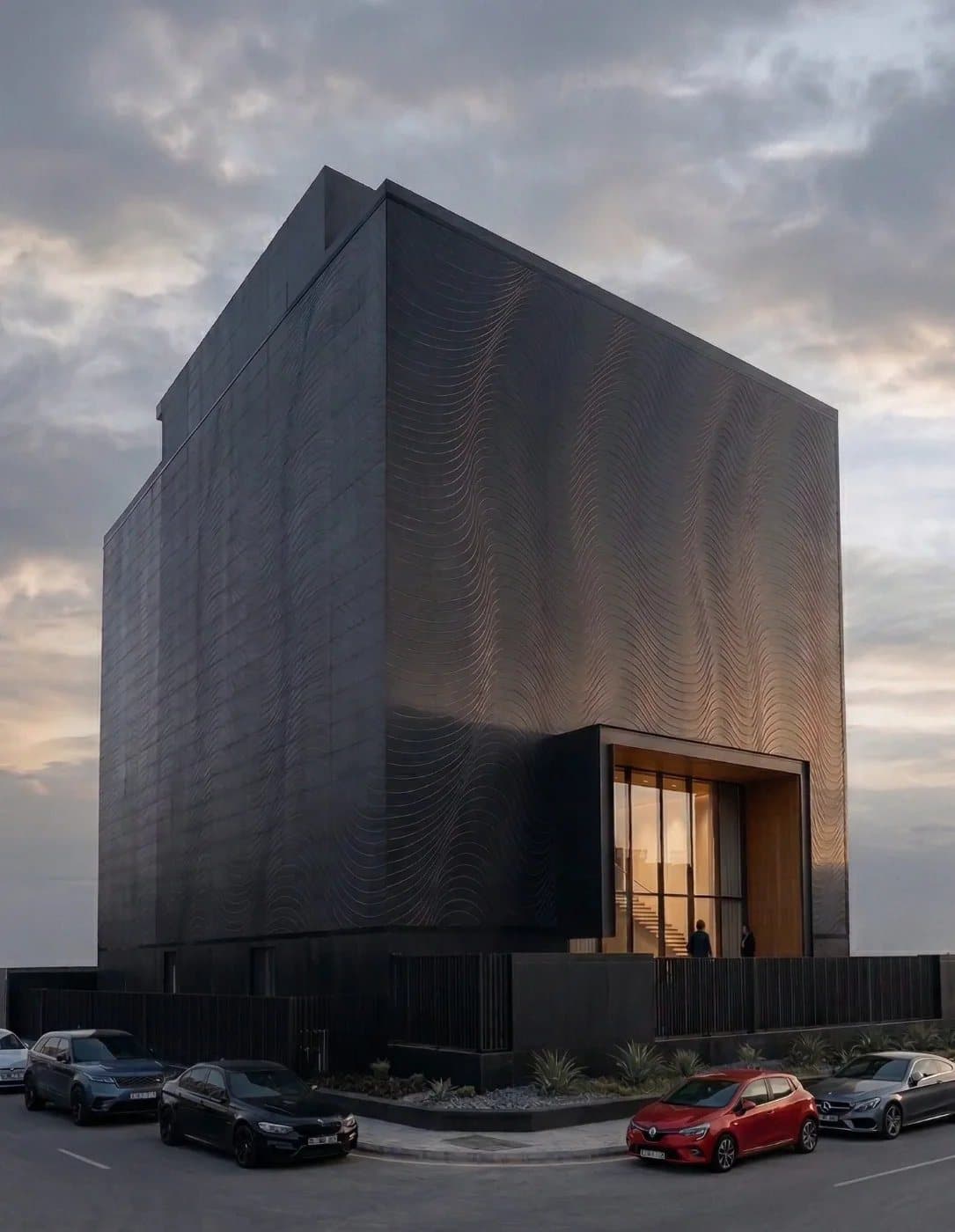 The monolithic bespoke-tile façade of the Tayo Living gallery at dusk